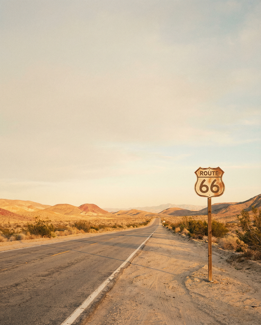 Route 66 desert highway at golden hour with vintage road sign and open road