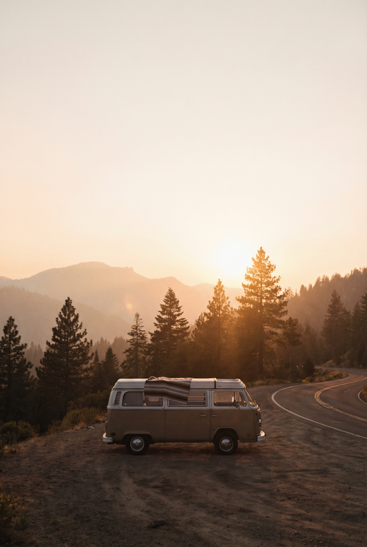 Vintage van on a mountain road at golden hour with pine trees and outdoor road trip scenery