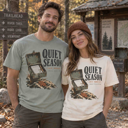 Couple wearing Bay and Ivory Quiet Season Trail Register graphic tees at an autumn hiking trailhead