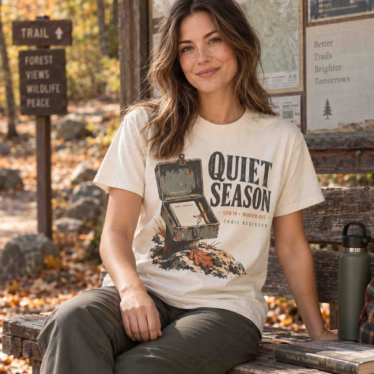 Hiker wearing a Bay Quiet Season Trail Register graphic tee near an autumn trailhead