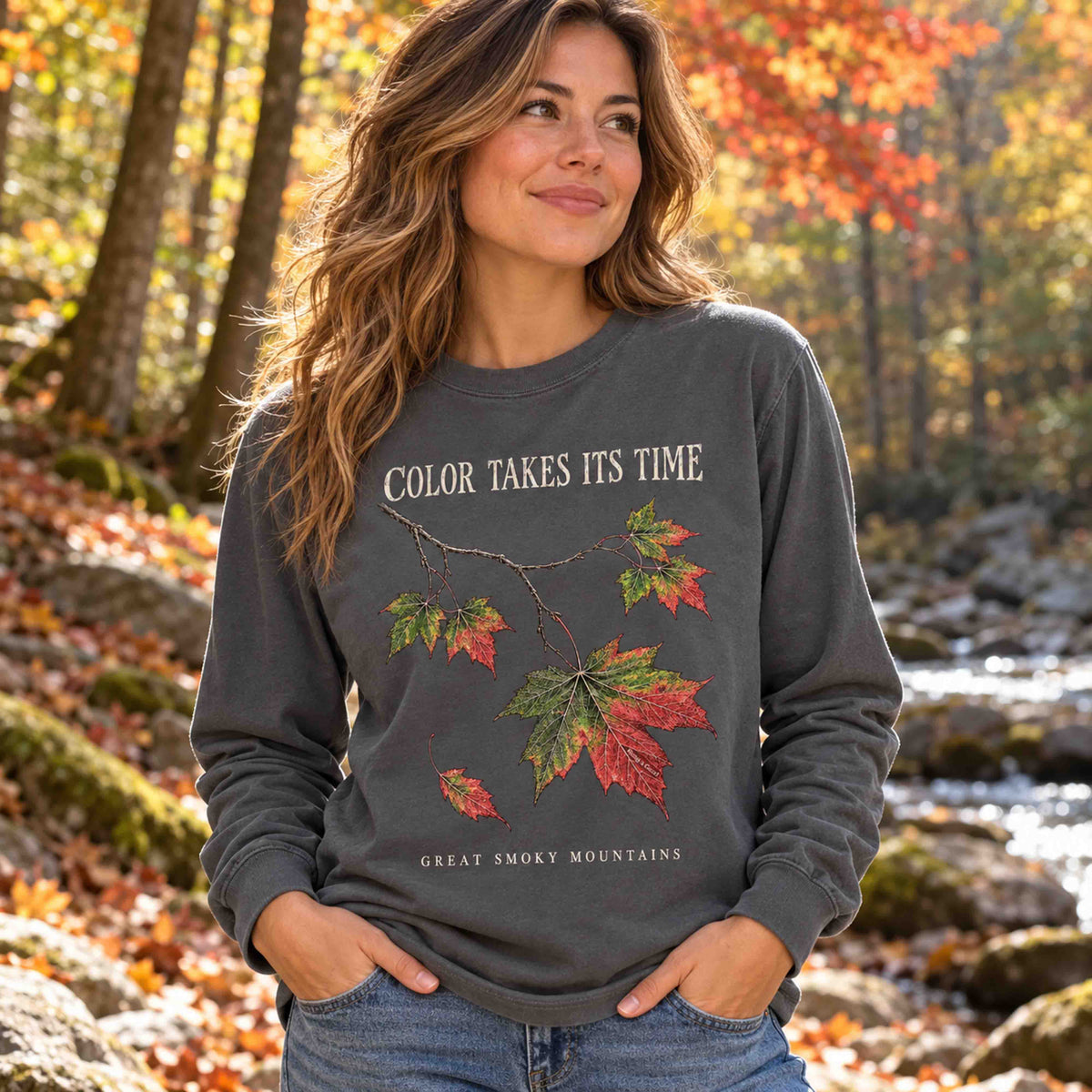 Woman wearing the Pepper maple leaf long sleeve shirt in an autumn woodland.