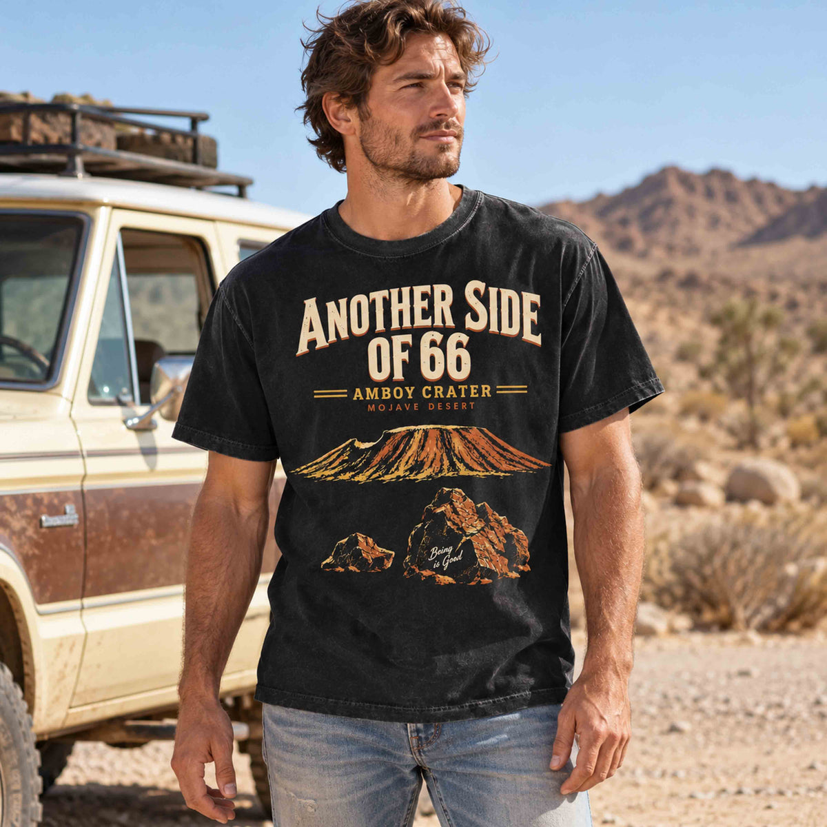 Black Amboy Crater Route 66 t-shirt worn by an adult model beside a desert road