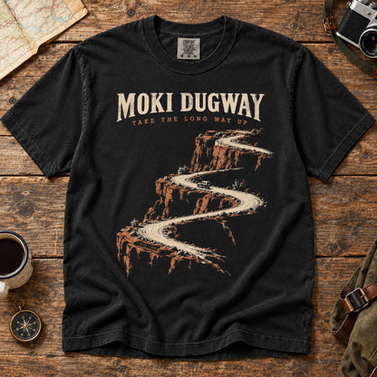 Overhead view of a Black Moki Dugway Utah T-shirt with winding desert road artwork.