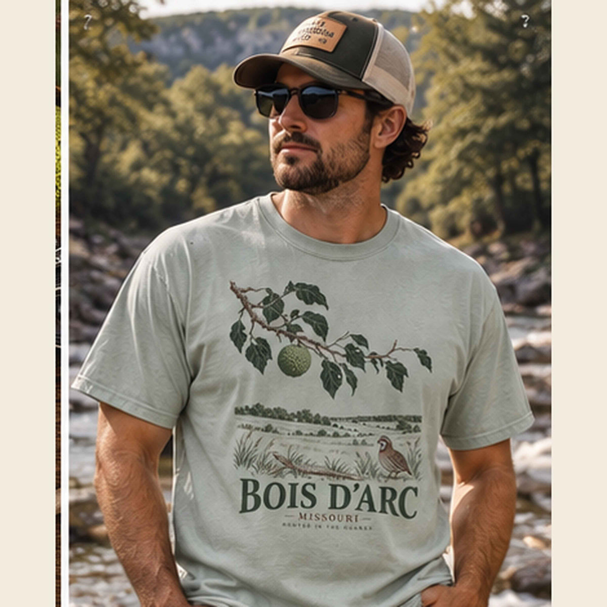 Man wearing a Bay Bois D'Arc Missouri graphic T-shirt outdoors with a cap and sunglasses.
