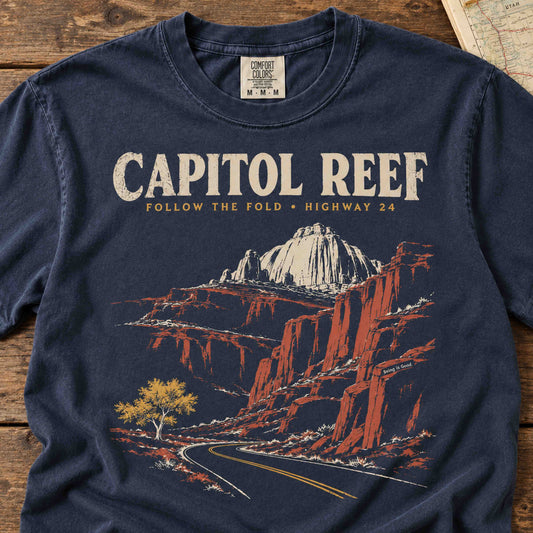 Close-up of Capitol Reef Highway 24 t-shirt print with sandstone cliffs, winding road and retro lettering.