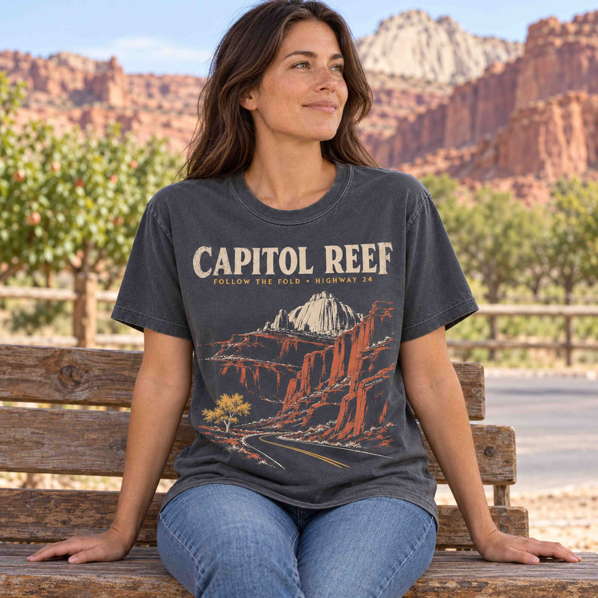 Capitol Reef National Park graphic tee shown in an outdoor orchard-inspired lifestyle setting.