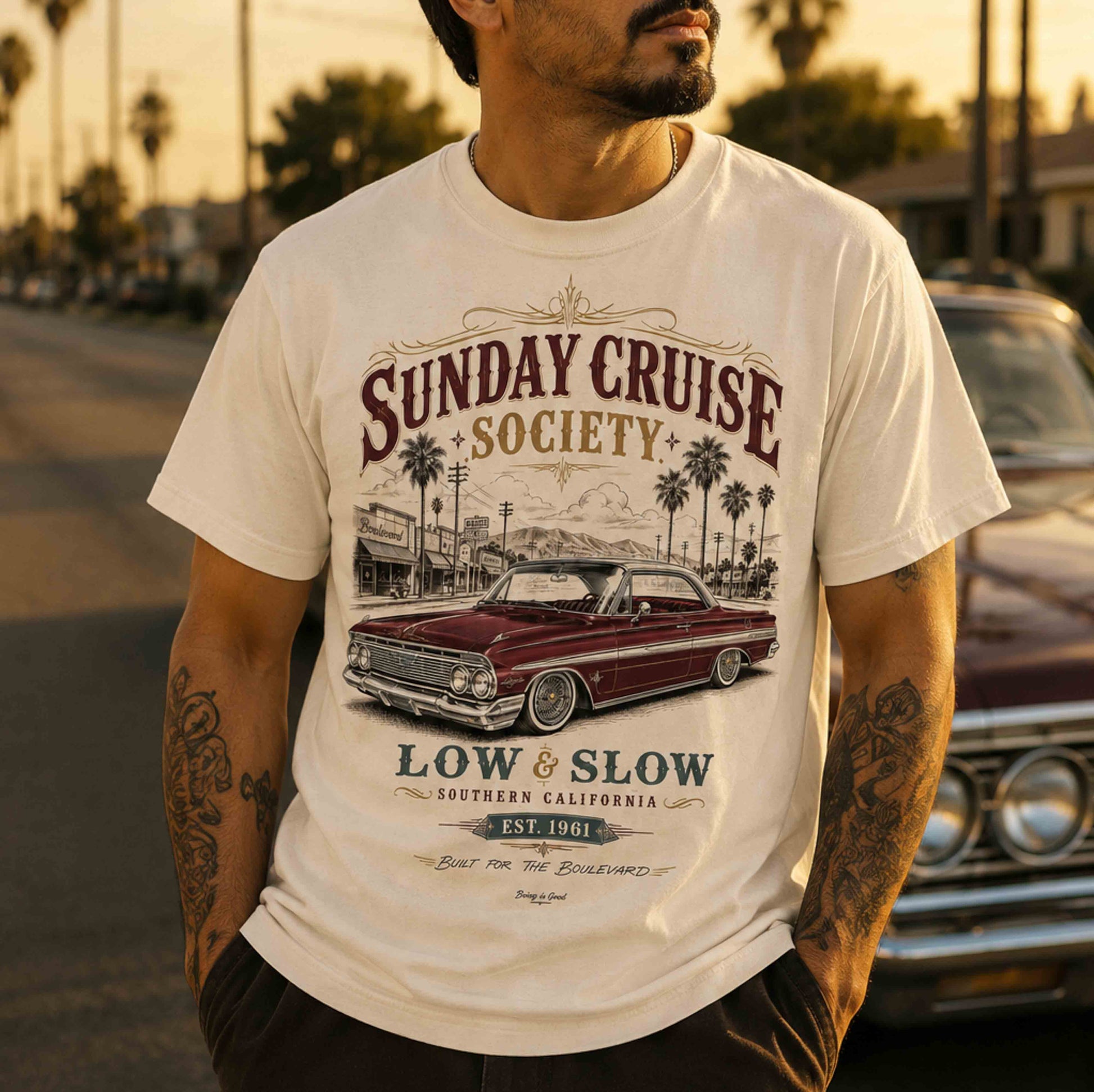 Sunday Cruise Society graphic T-shirt styled with a classic lowrider at golden hour