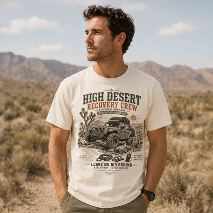 Man wearing an off-road trail recovery T-shirt surrounded by Joshua trees and desert mountains