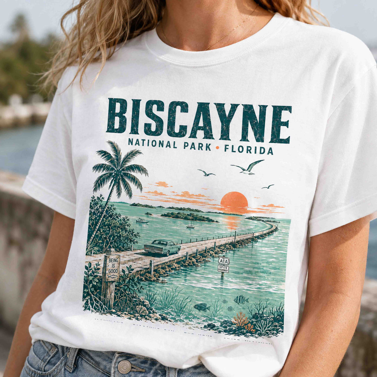 Biscayne National Park Florida Keys graphic tee worn by female model near the water
