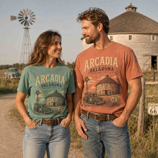 Arcadia Oklahoma Route 66 Historic Round Barn graphic tee worn by a couple in a vintage roadside setting.