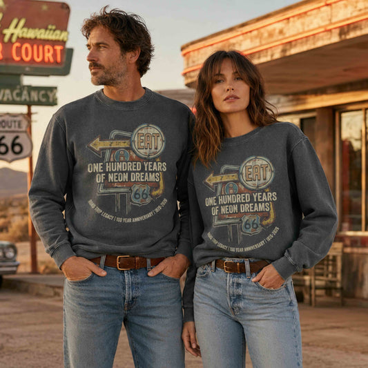 Couple wearing Route 66 Neon Dreams Centennial graphic sweatshirts at a vintage roadside motel