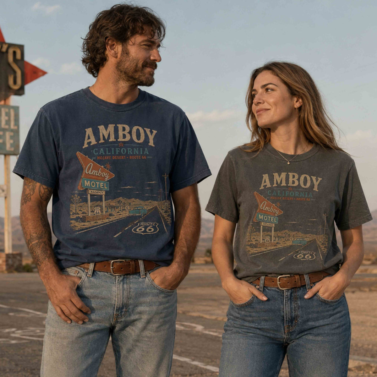 Couple wearing Amboy California Route 66 graphic tees near Roy’s Motel in the Mojave Desert.