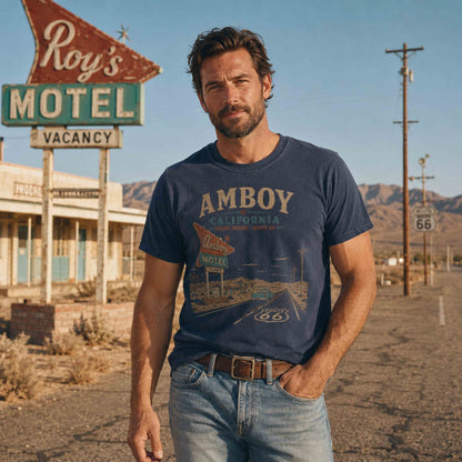 Woman wearing a Pepper Amboy California Route 66 Roy’s Motel graphic tee near historic desert roadside scenery.