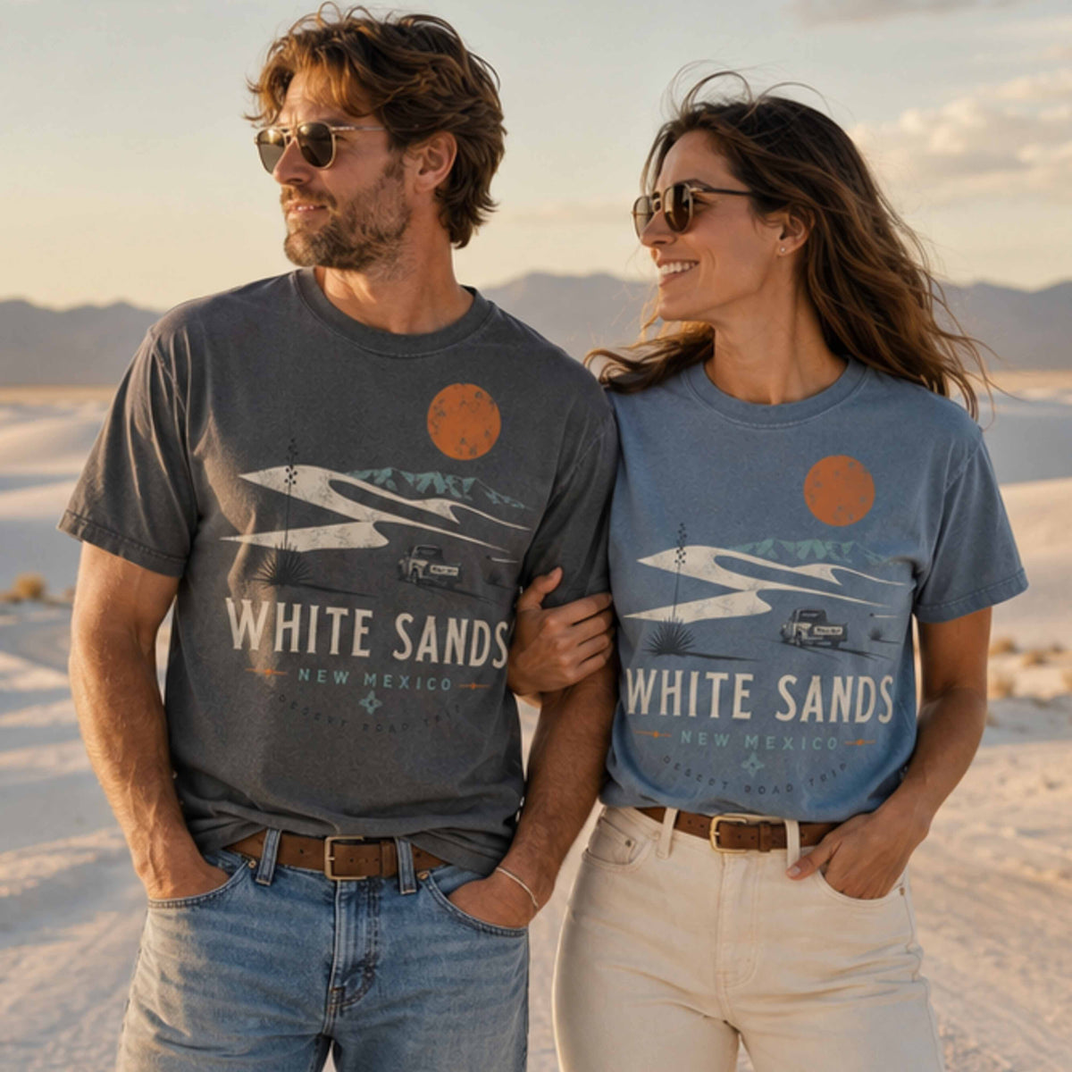 Couple wearing White Sands New Mexico Desert Road Trip graphic tees at White Sands dunes