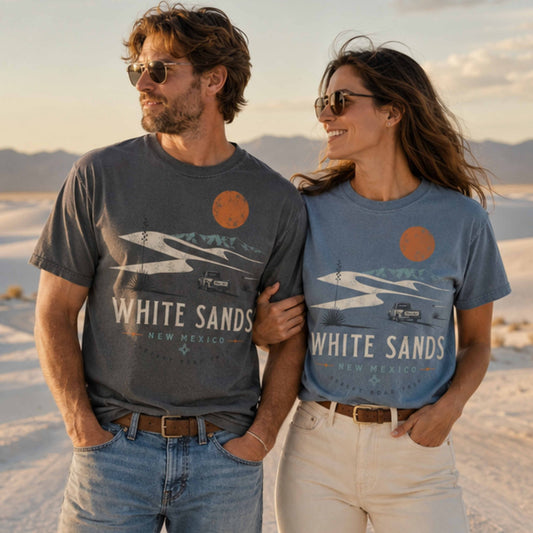 Couple wearing White Sands New Mexico Desert Road Trip graphic tees at White Sands dunes