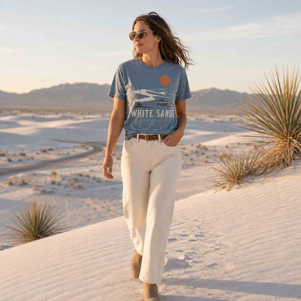Woman wearing White Sands New Mexico Desert Road Trip graphic tee at White Sands dunes