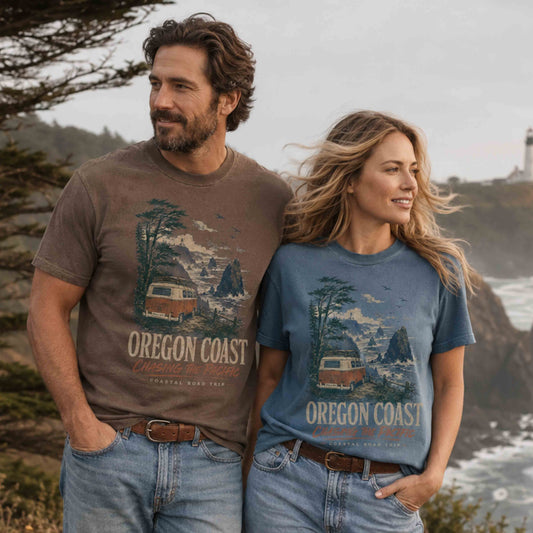 Couple wearing Oregon Coast Chasing the Pacific Road Trip graphic tees on the Oregon coast