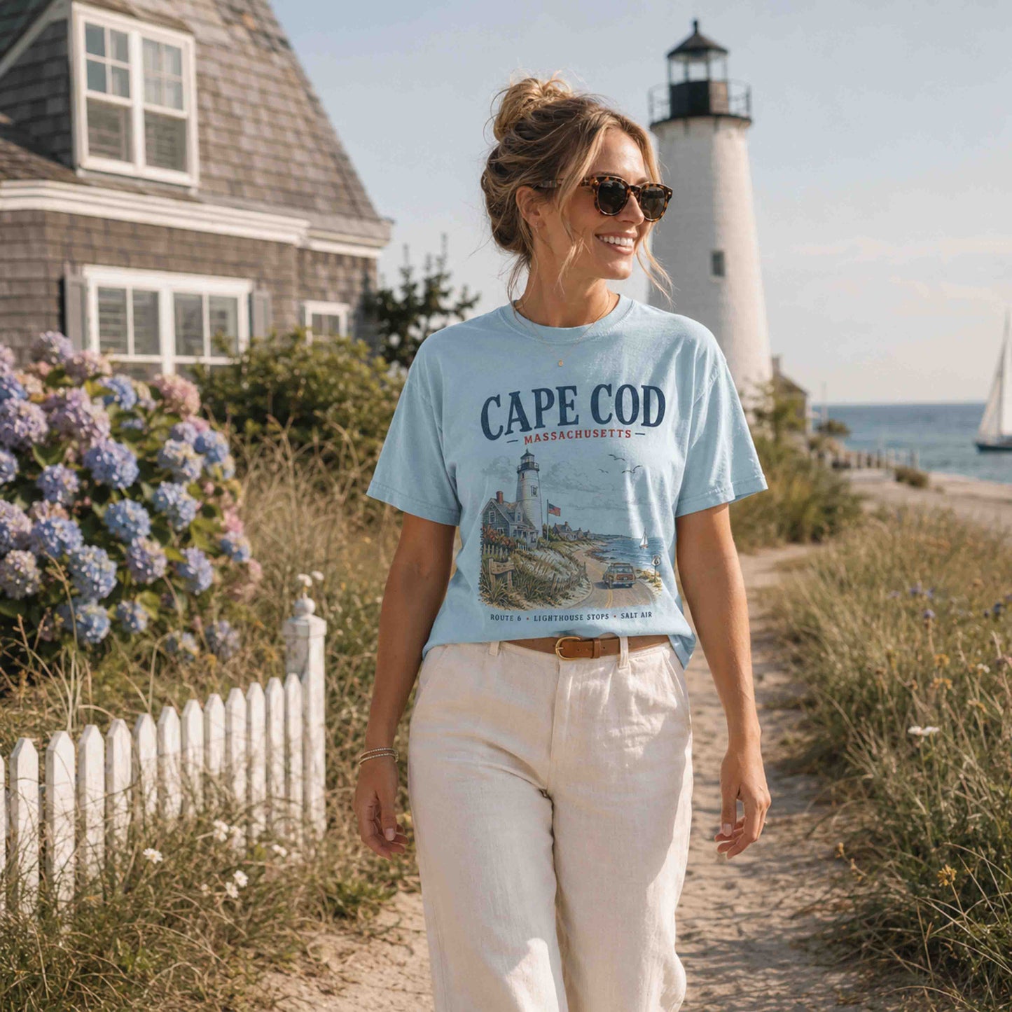 Female model wearing Chambray Cape Cod Massachusetts graphic tee near the beach