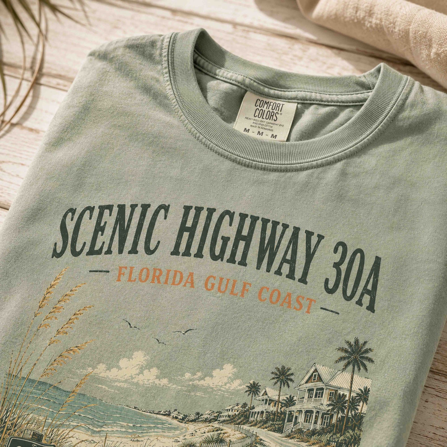 Close-up of Scenic Highway 30A vintage coastal artwork on premium cotton tee