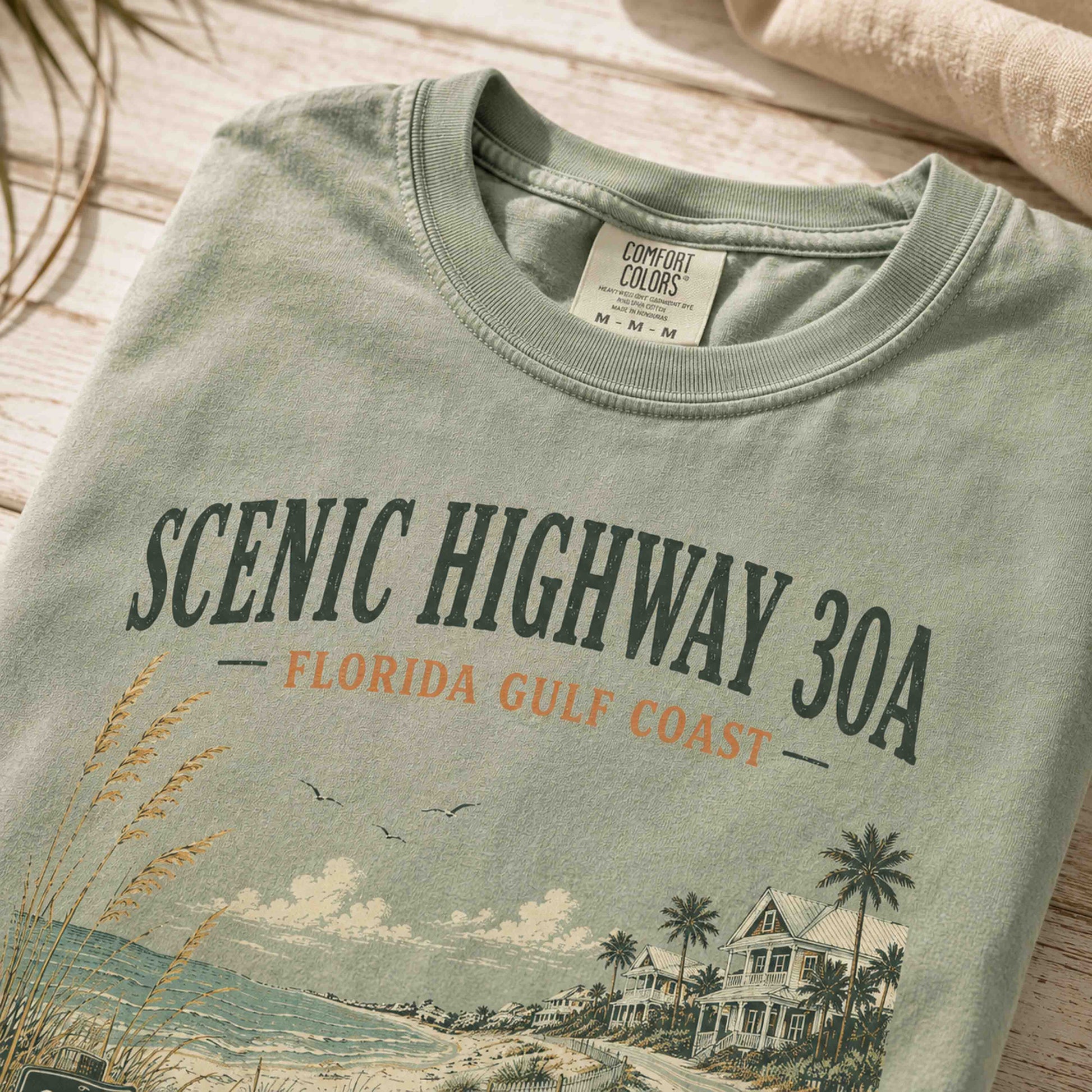 Close-up of Scenic Highway 30A vintage coastal artwork on premium cotton tee