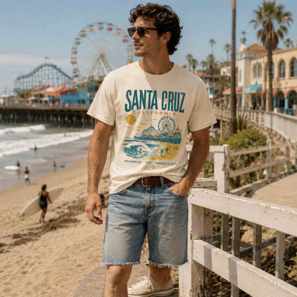 Male model wearing Ivory Santa Cruz California graphic tee near the boardwalk