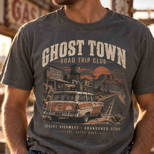Close-up of a man wearing the charcoal Ghost Town Road Trip Club vintage desert highway graphic tee.