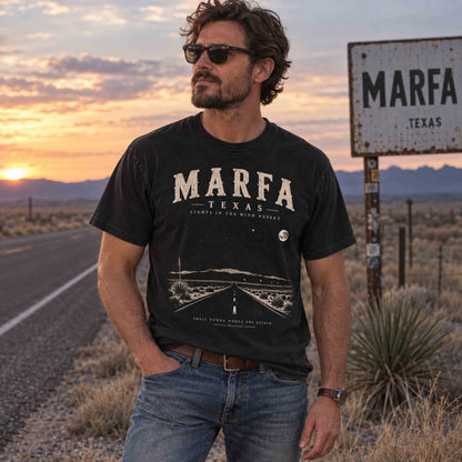 Marfa Texas graphic tee lifestyle image featuring West Texas desert scenery and Lights in the High Desert road trip artwork