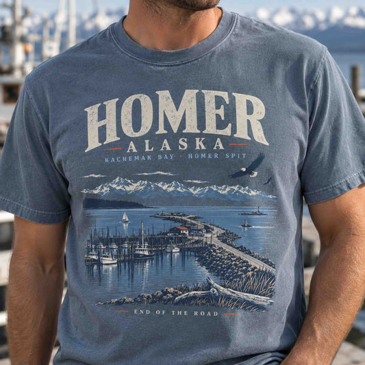 Homer Alaska Kachemak Bay graphic tee lifestyle view with Homer Spit harbor and snow-covered mountains