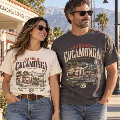Couple wearing Rancho Cucamonga California Route 66 graphic tees featuring historic Foothill Boulevard artwork in Ivory and Pepper.