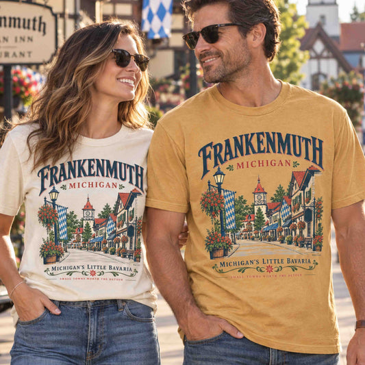 Frankenmuth Michigan Little Bavaria graphic tees worn by a couple in a Bavarian-style downtown setting