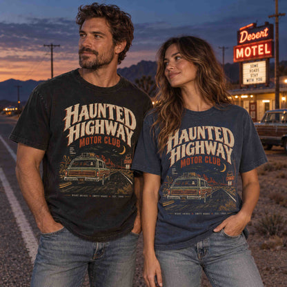 Couple wearing Haunted Highway Motor Club vintage road trip graphic tees at a desert roadside motel at sunset