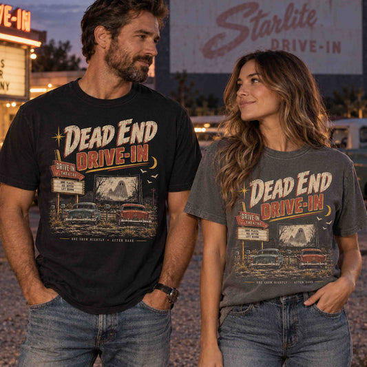 Man and woman wearing Dead End Drive-In vintage haunted Americana graphic tees at a retro drive-in theater