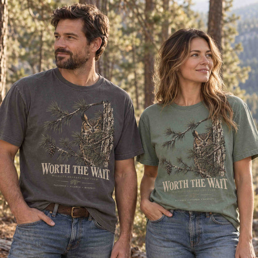 Couple wearing Worth the Wait Wildlife Observation Club graphic tees in Pepper and Moss outdoors
