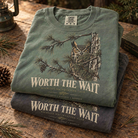 Lifestyle view of Worth the Wait Wildlife Observation Club graphic tees worn outdoors