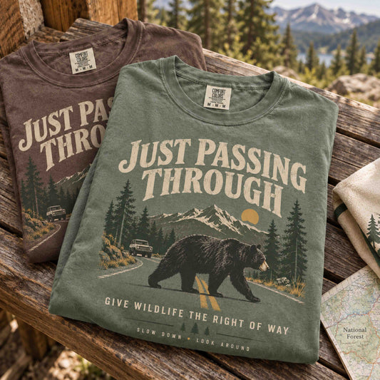 Just Passing Through Bear Wildlife Right of Way graphic tee in Moss featuring a black bear, mountain road, pine trees, and vintage outdoor artwork.