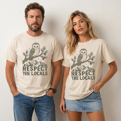 Comfort Colors graphic tee featuring a cute owl perched on a pine branch with mountain artwork and “Respect The Locals” text.