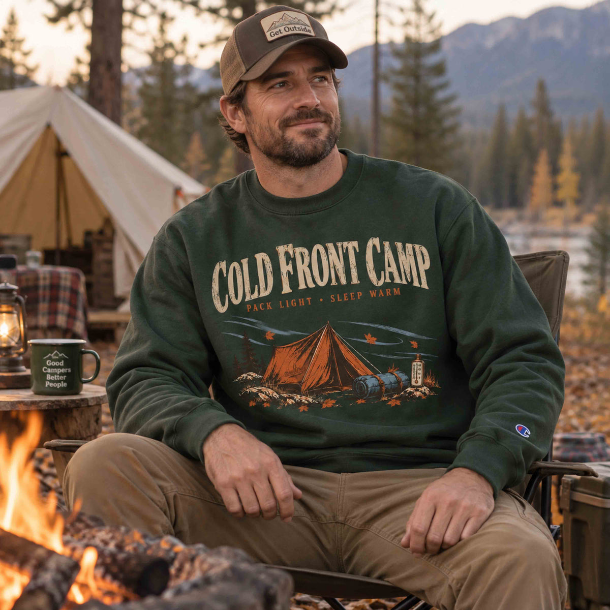 Men wearing Dark Green Cold Front Camp Champion graphic sweatshirt at an autumn pine campground