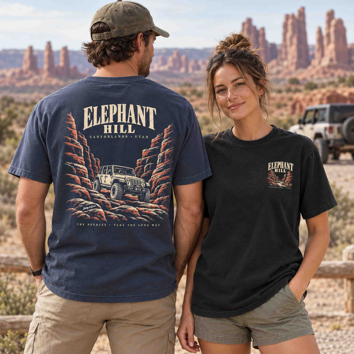 Couple wearing Being is Good Elephant Hill tees, showing the Navy canyon back graphic and Black left-chest print.
