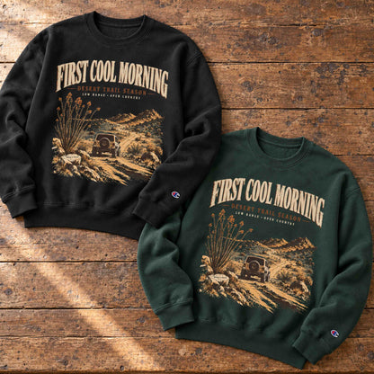 Black and Dark Green Champion First Cool Morning Desert Trail graphic sweatshirts displayed on aged wood