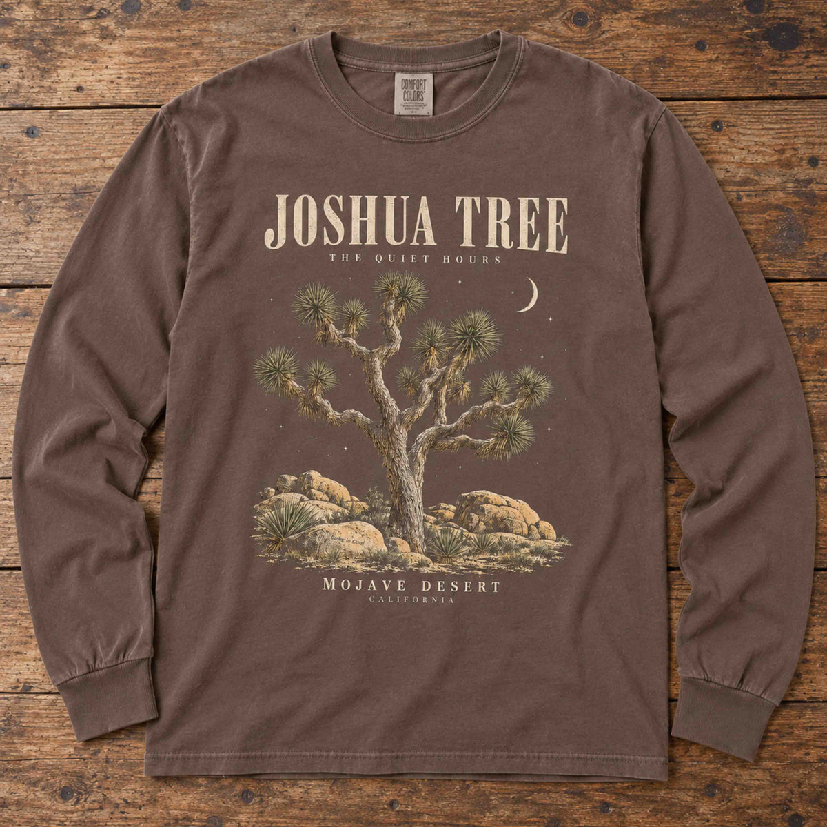 Espresso Joshua Tree long sleeve shirt laid flat, showing tree, boulders, crescent moon and The Quiet Hours lettering.
