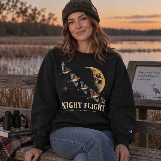 Night Flight Bird Migration Champion sweatshirt worn at golden hour beside wetlands with migrating birds overhead