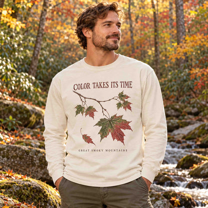 Man wearing the Ivory Smoky Mountains maple leaf long sleeve shirt in autumn woods.