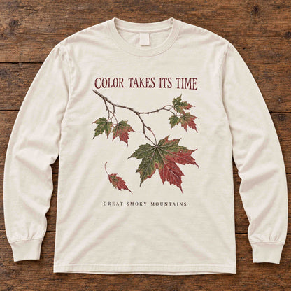 Ivory Color Takes Its Time long sleeve shirt laid flat on a wooden surface.