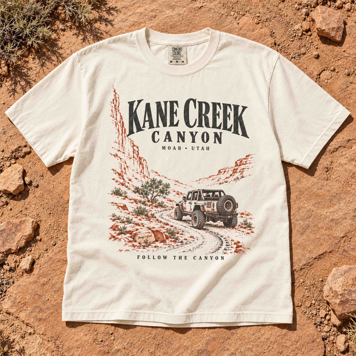 Ivory Kane Creek Canyon graphic tee laid flat, showing the off-road vehicle design.