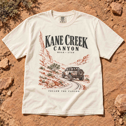 Ivory Kane Creek Canyon graphic tee laid flat, showing the off-road vehicle design.