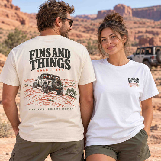 Couple wearing Being is Good Fins and Things Moab tees: Ivory back graphic and White left-chest print.