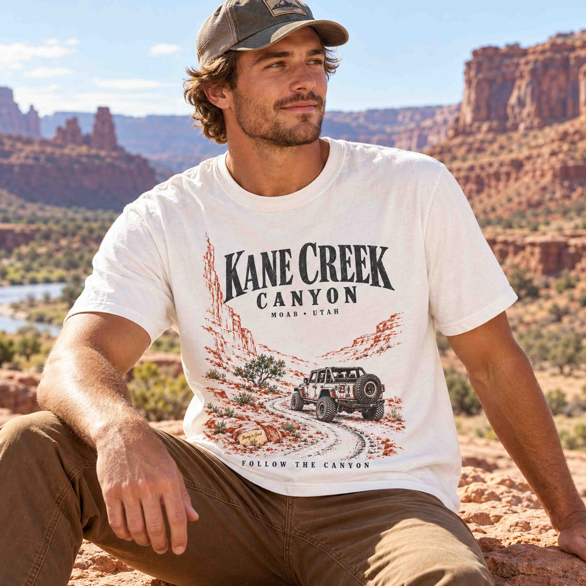 Man wearing an Ivory Kane Creek Canyon graphic tee in a desert setting.