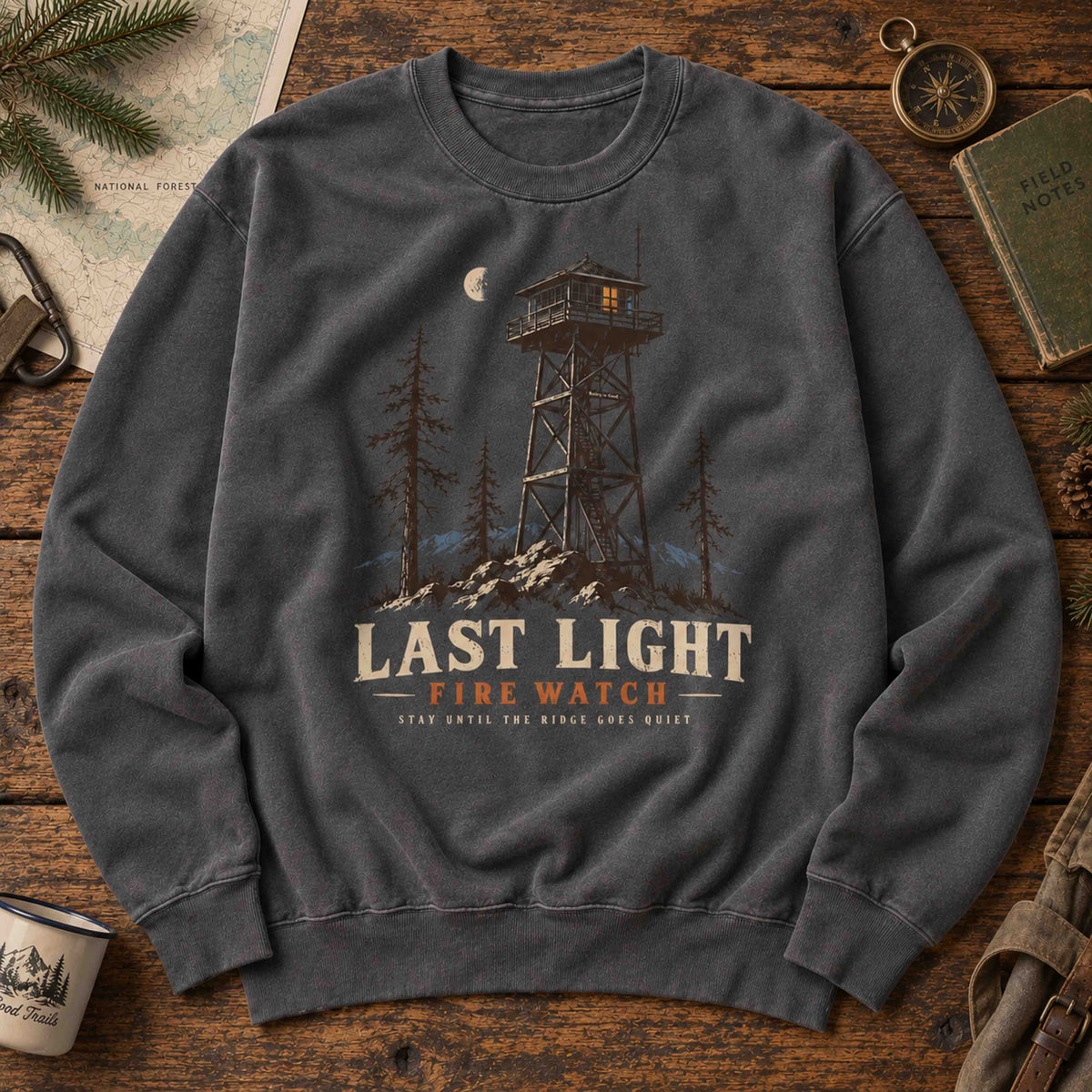 Last Light Fire Watch graphic sweatshirt flat lay featuring vintage mountain lookout artwork