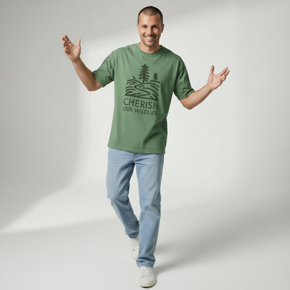 Full body shot of a man walking forward and smiling, wearing a green "Cherish Our Wildlife" graphic tee and light blue jeans.