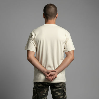 Back view of a man modeling a blank, relaxed-fit cream heavyweight t-shirt.